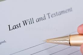 A gold pen hovers above a piece of white paper reading: Last Will and Testament.